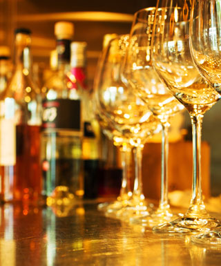 Wine glasses lined up on a bar with beer taps in the background at Hollywood Casino Joliet